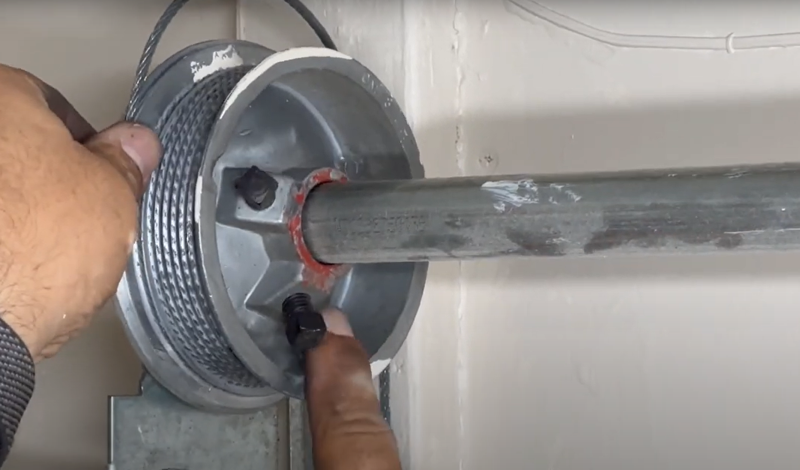 Professional technician performing garage door cable repair in Baltimore, OH, illustrating precise and reliable service