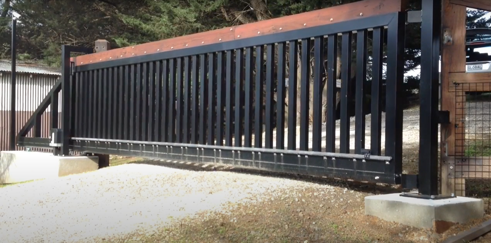 Professional technician repairing a commercial gate, focusing on adjusting and inspecting mechanical components. Keywords: commercial gate repair, Garage Door Repair Granville Ohio