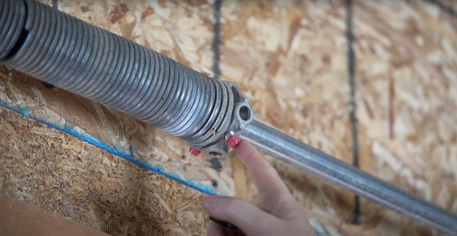 a skilled technician performing garage door spring repair in Granville, Ohio, highlighting the precision and safety measures taken during the process.