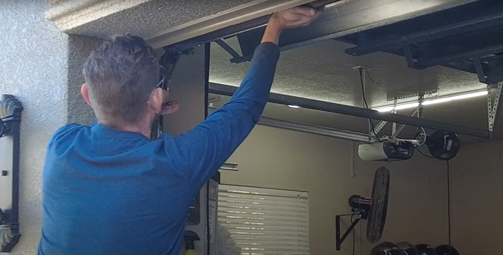 Professional technician performing overhead garage door repair in Granville, Ohio, showcasing expert service and precision tools.