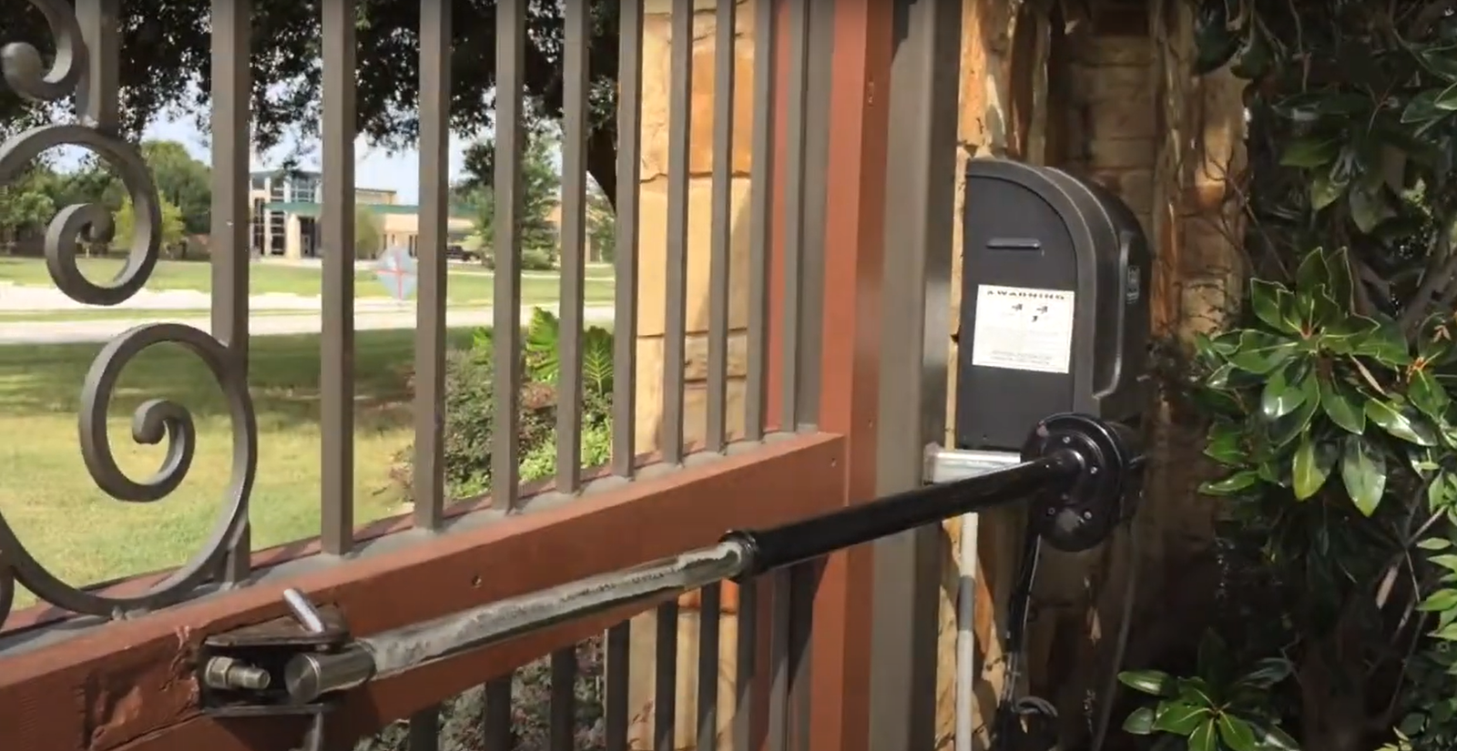 Professional technician repairing a residential gate mechanism with tools, highlighting the repair process