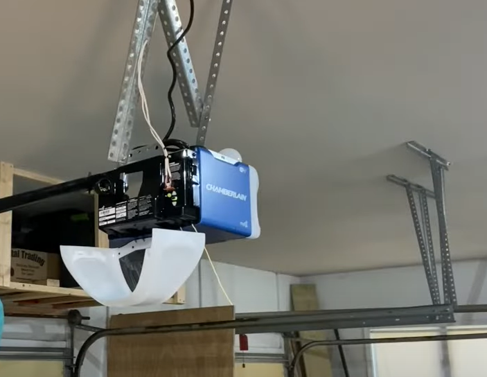 a technician fixing a residential garage door opener in Granville, Ohio, showcasing professional repair services by Garage Door Repair Granville Ohio LLC.