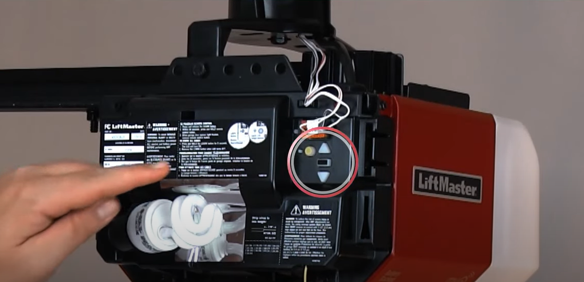 a technician repairing a garage door opener in Granville, Ohio, showcasing professional repair services for residential garage doors.
